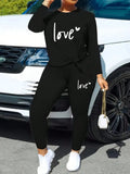 Black love-letter long-sleeve top and tight-leg elastic-waist pants set, round neck