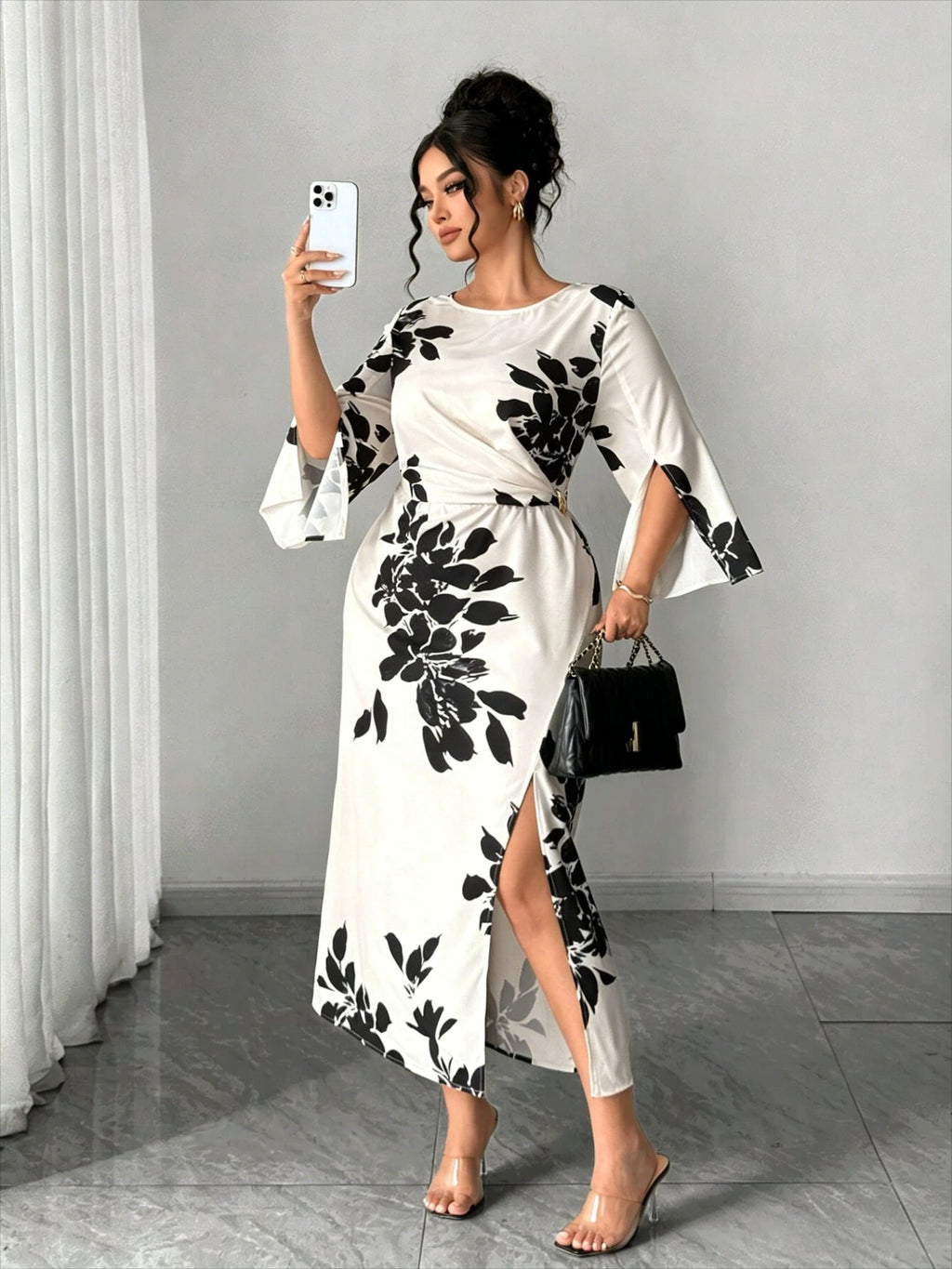 White midi dress with black floral print, short bell sleeves, front slit, fitted waist