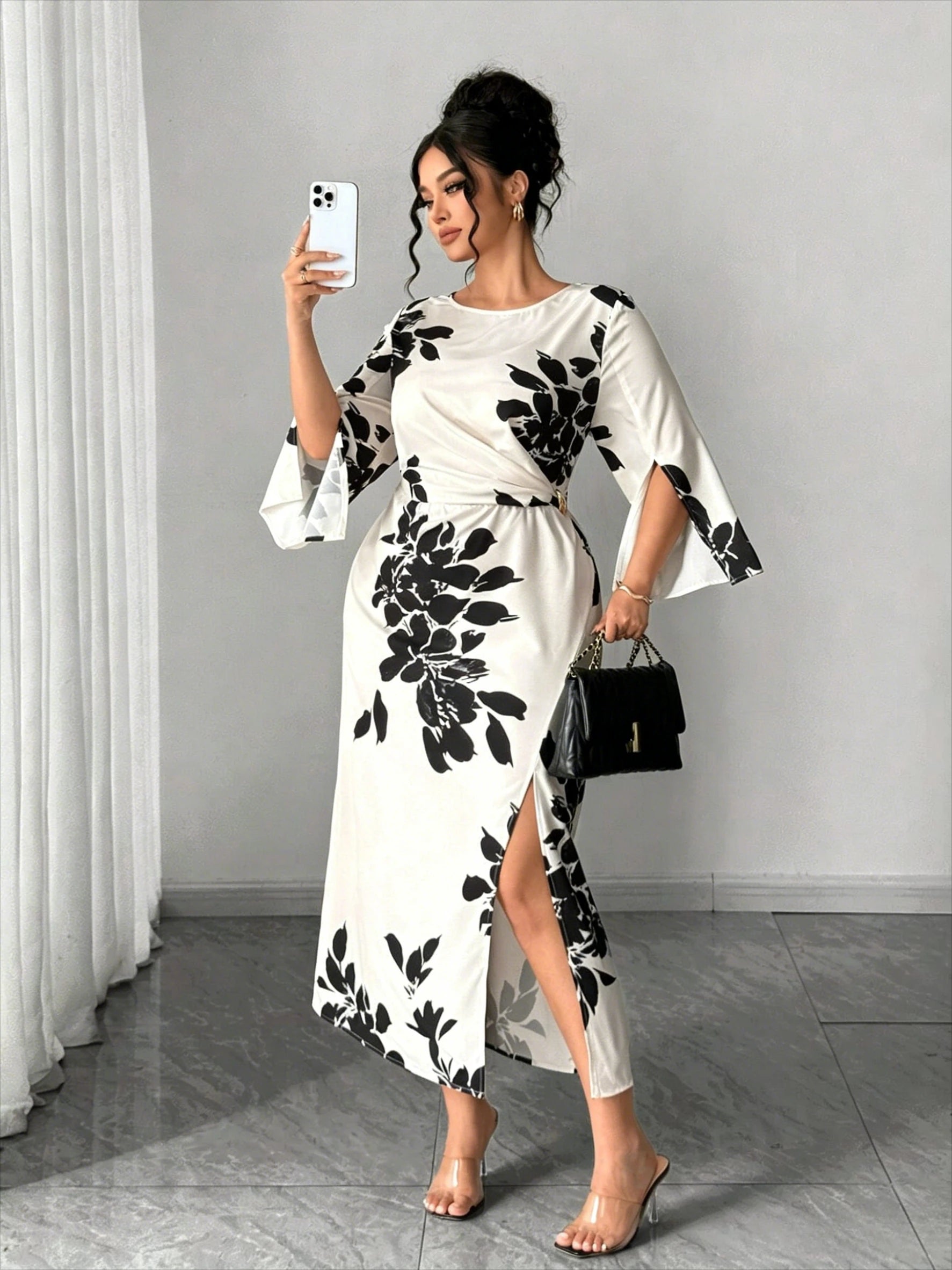 White midi dress with black floral print, short bell sleeves, front slit, fitted waist