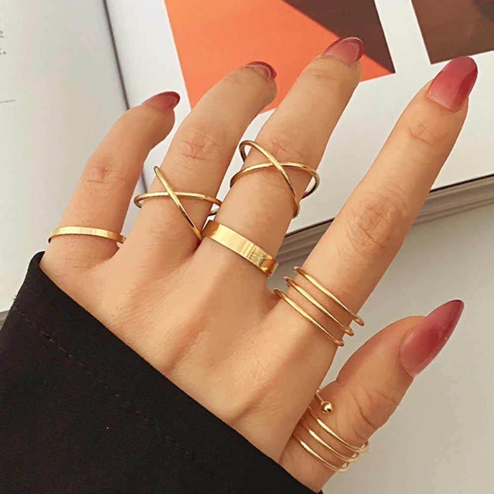 Gold knuckle ring set with linked bands and stacked finger rings