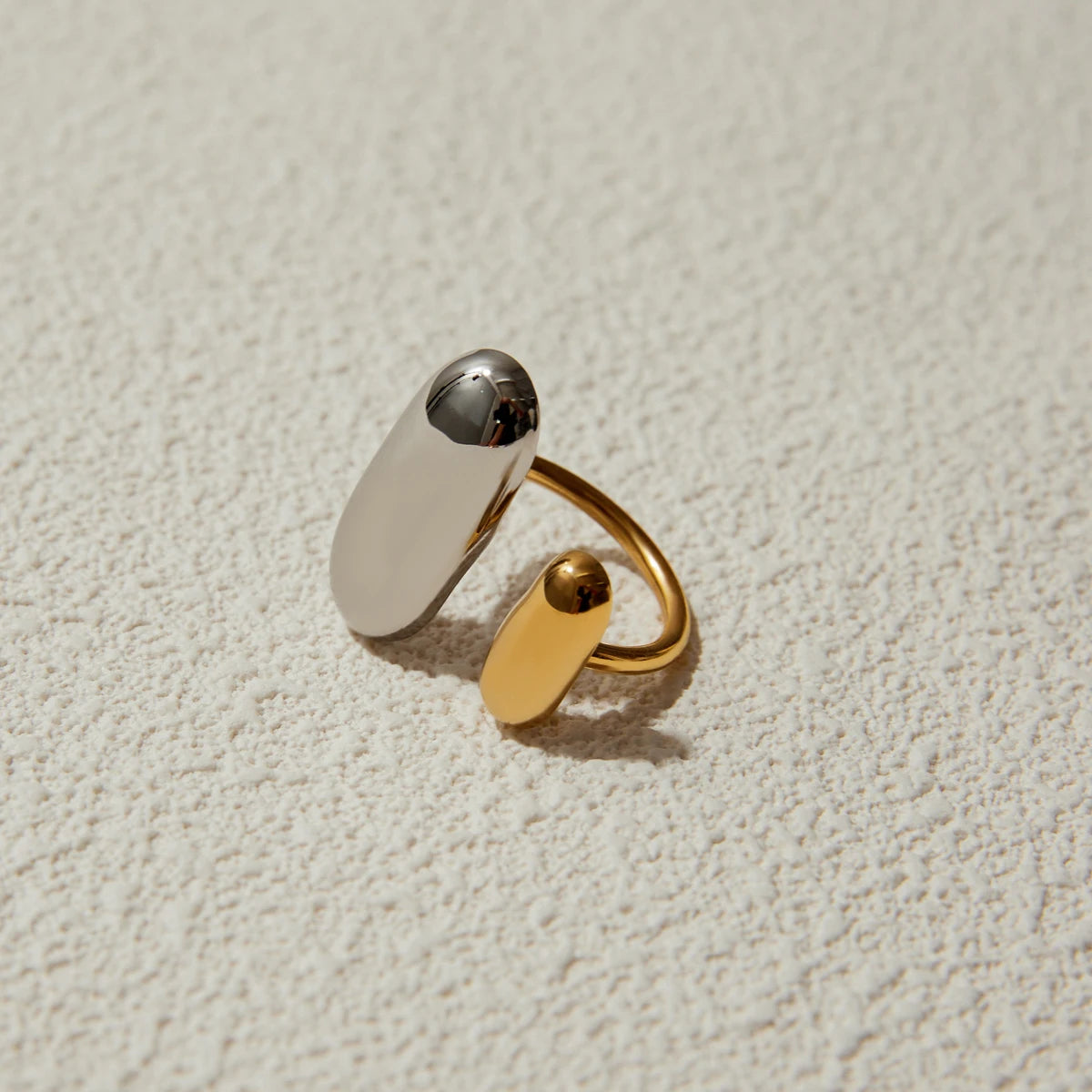 Geometric oval open ring with mixed gold and silver oval plates, polished finish