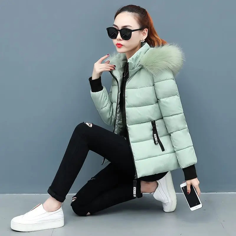 Mint green hooded puffer parka with faux fur hood trim and front zipper, quilted jacket
