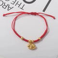 Red rope bracelet with gold beads and gold horse charm pendant.