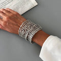 Silver-tone wide beaded cuff bracelet with stacked square bead bands.