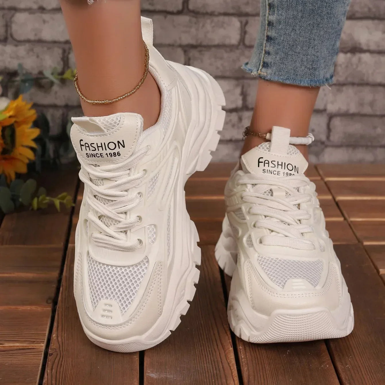 White chunky platform lace-up sneakers with perforated toe panel and thick sole