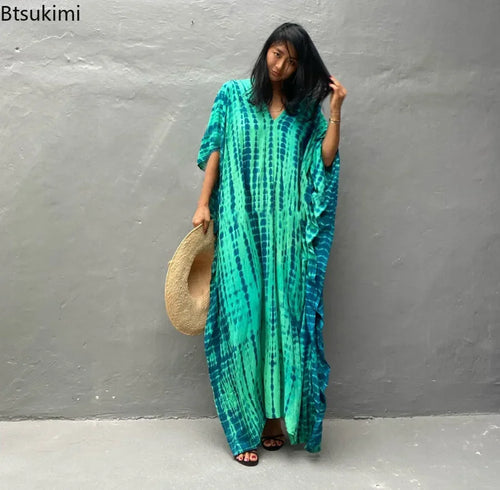Green printed beach dress with short sleeves, relaxed fit, and floor-length hem