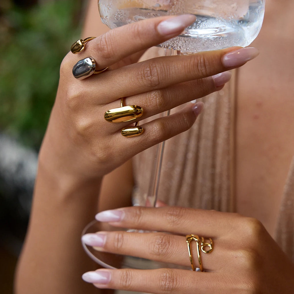 Gold geometric oval open ring with glossy oval face on finger