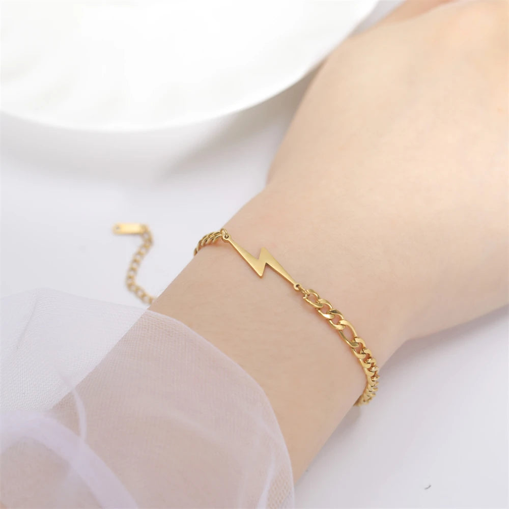 Gold-tone chain lightning bolt charm bracelet on wrist