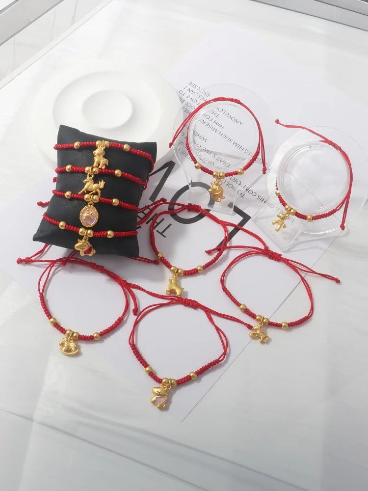 Mixed set of red rope horse charm bracelets with gold beads and pendants