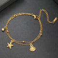 Gold-tone starfish and seashell charm bracelet with round gem accents