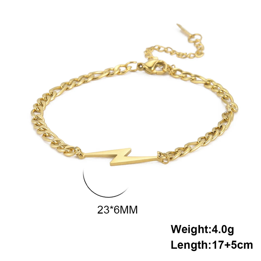 Gold tone lightning charm bracelet with chunky chain and white bolt centerpiece charm.