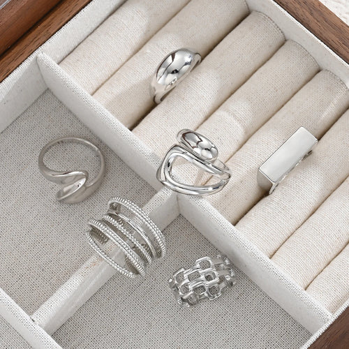 Silver-tone knuckle rings set in display box with wrapped bands and chain-link designs