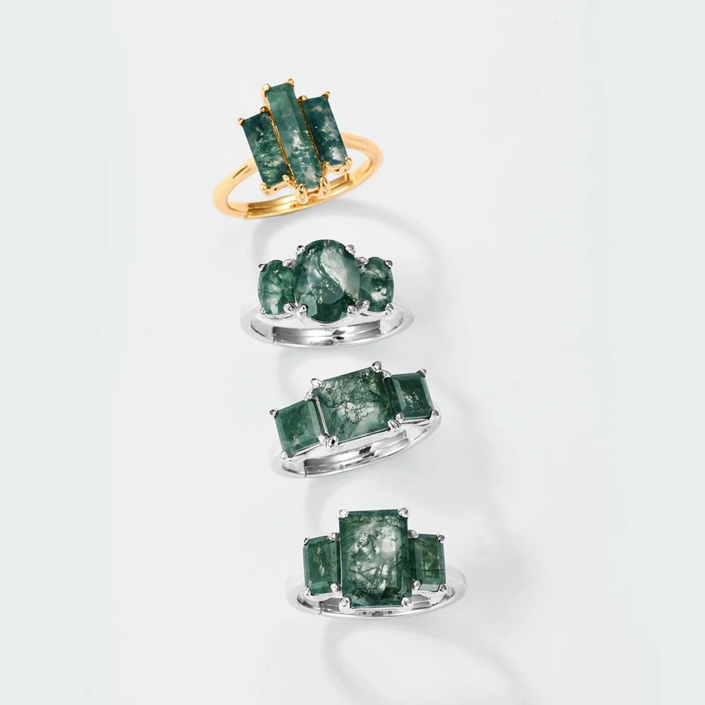 Three moss agate rings display, gold three-stone ring on top in sterling silver