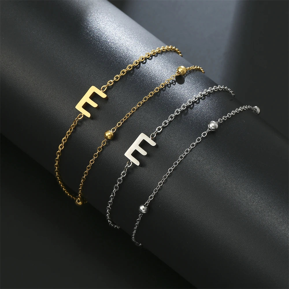Initial letter bracelet set with T and T charms; gold and silver-tone chains