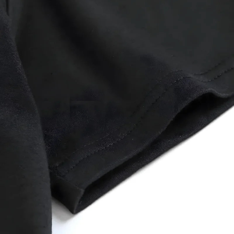 Women's black T-shirt neckline and hem stitching close-up