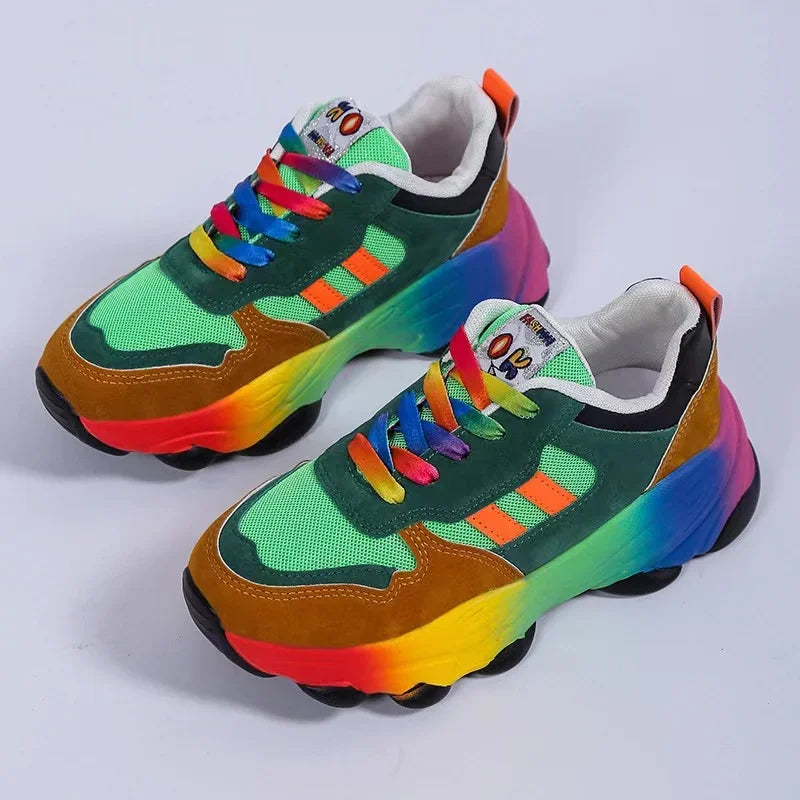 Platform sneakers with green upper, orange laces, and chunky rainbow tread sole.