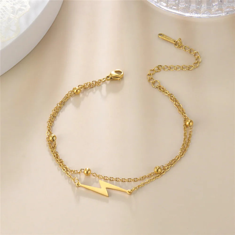Gold-tone chain lightning charm bracelet with two small bolt charms