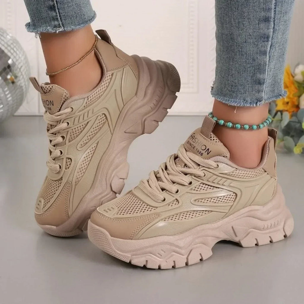 Beige chunky platform lace-up sneakers with perforated panels and thick sole