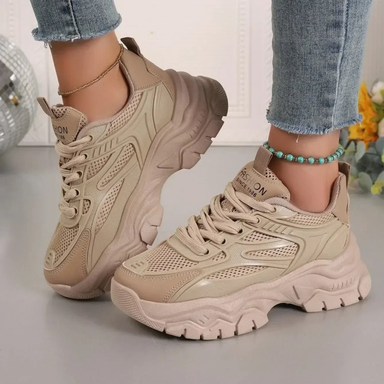 Beige chunky platform lace-up sneakers with perforated panels and thick sole