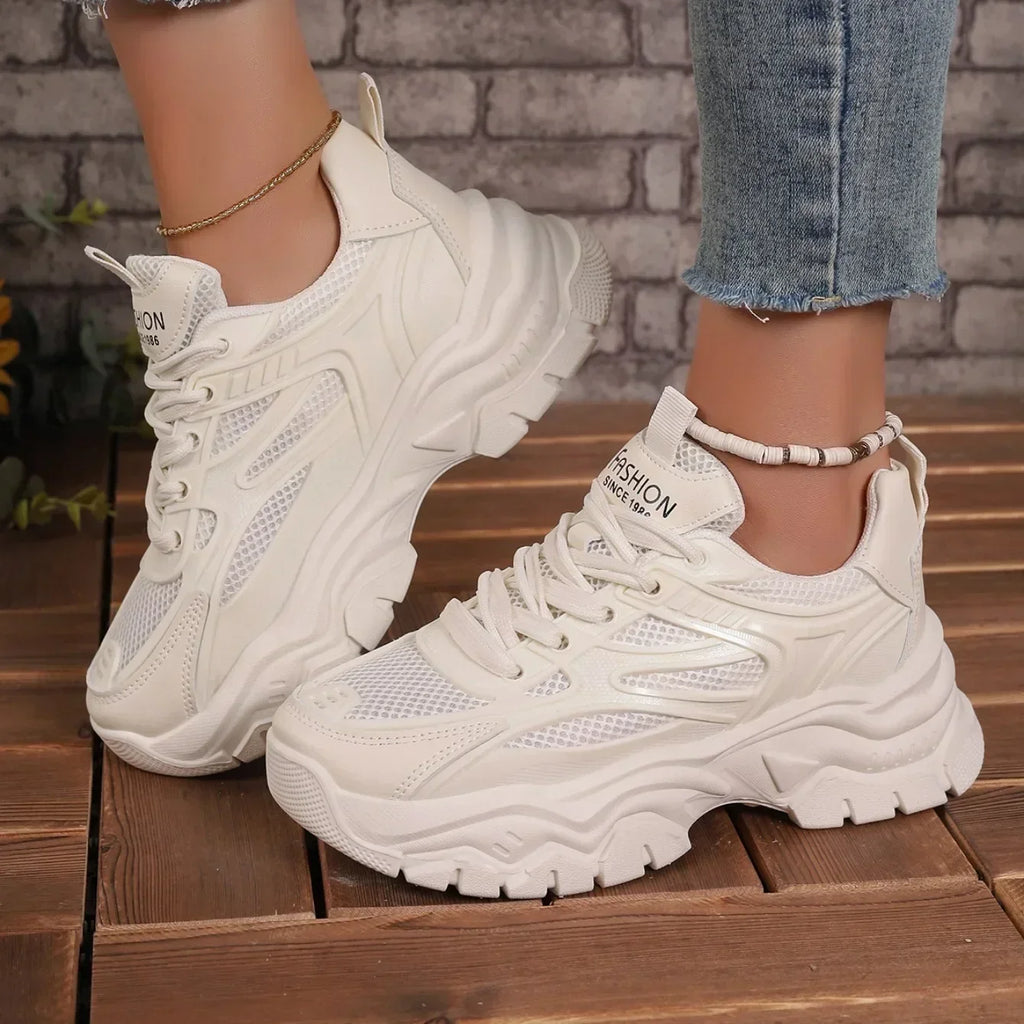 White chunky platform lace-up sneakers with perforated upper and rugged sole