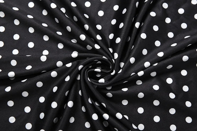 Black polka dot fabric with white dots