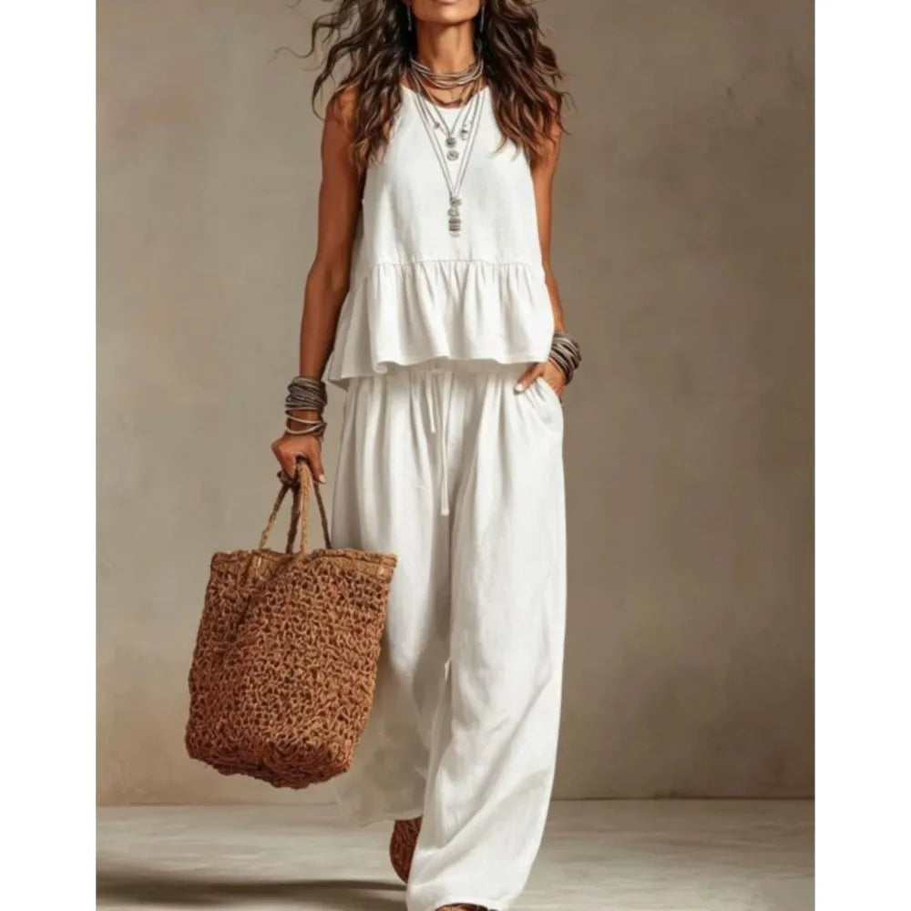 White sleeveless ruffled top and wide-leg trouser set with tiered peplum
