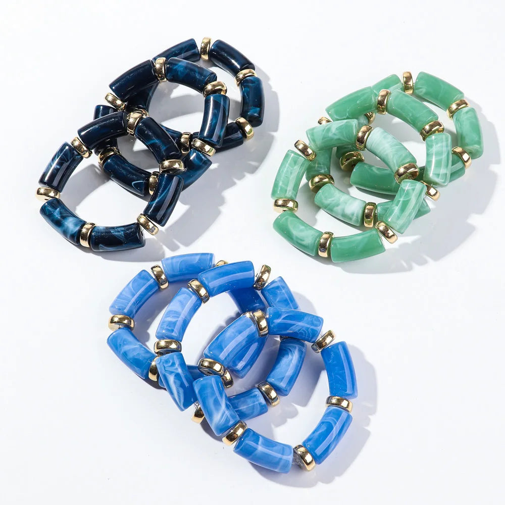 Bamboo tube bead bracelet set with navy, mint green, and light blue tubes with gold accents