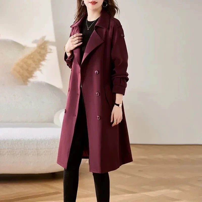 Women’s burgundy trench coat with long sleeves, notched lapels, and double-button front