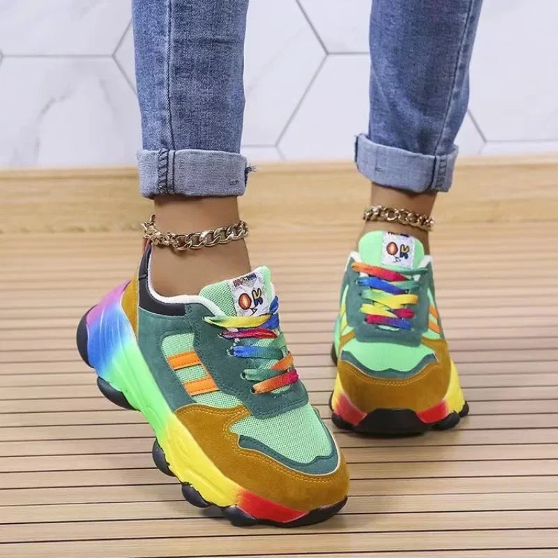 Platform sneakers in teal and green with rainbow accents, thick sole, and lace-up closure.