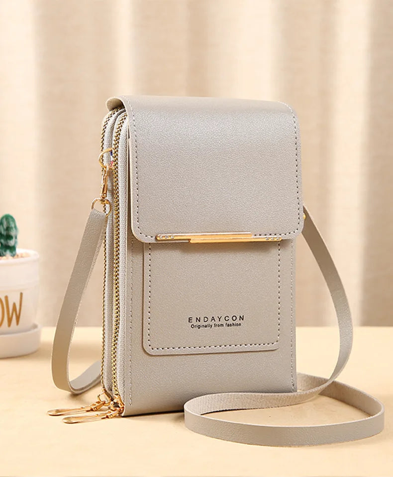 Light gray PU phone crossbody wallet with top flap, gold zipper, and crossbody strap.