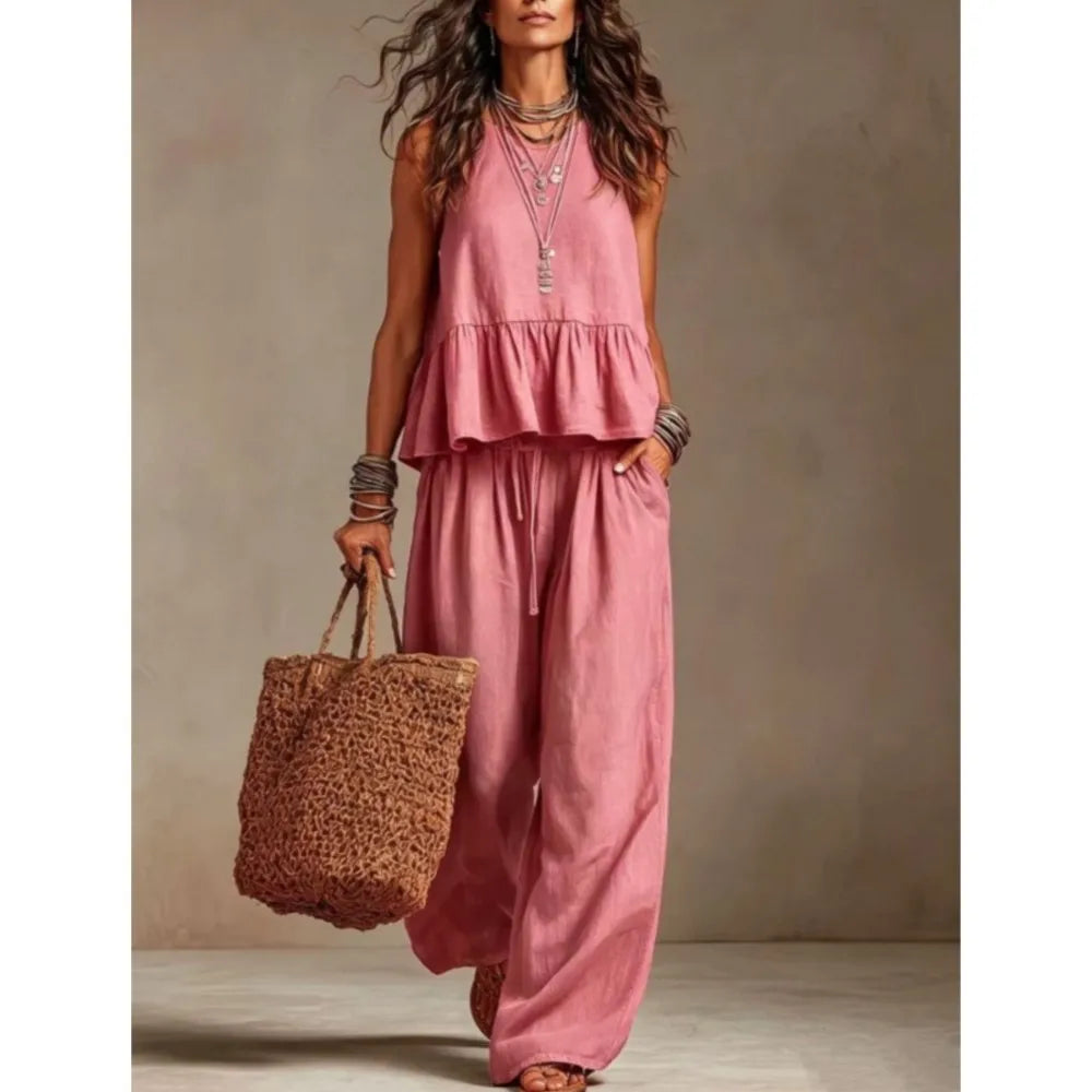 Pink sleeveless ruffled top and wide-leg trouser set with tiered peplum