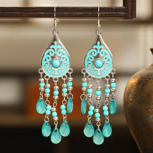 Turquoise teardrop bead tassel dangle earrings with ornate center and silver hooks