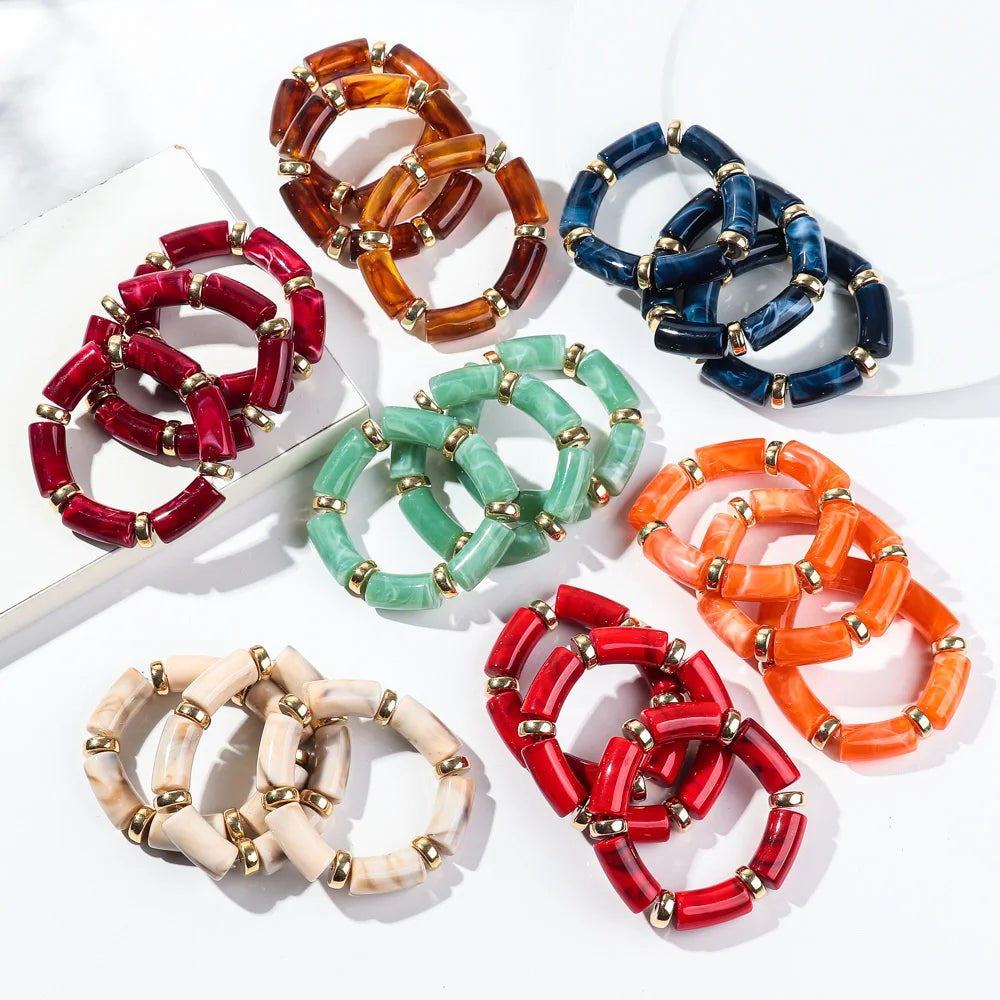Bamboo tube bead bracelet set in red, amber, teal green, and navy with gold-tone links