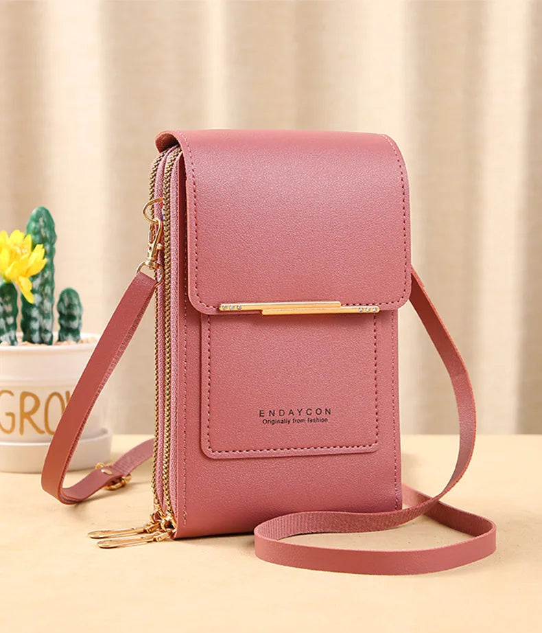 Pink PU phone crossbody wallet with top flap, gold zipper, and adjustable strap.