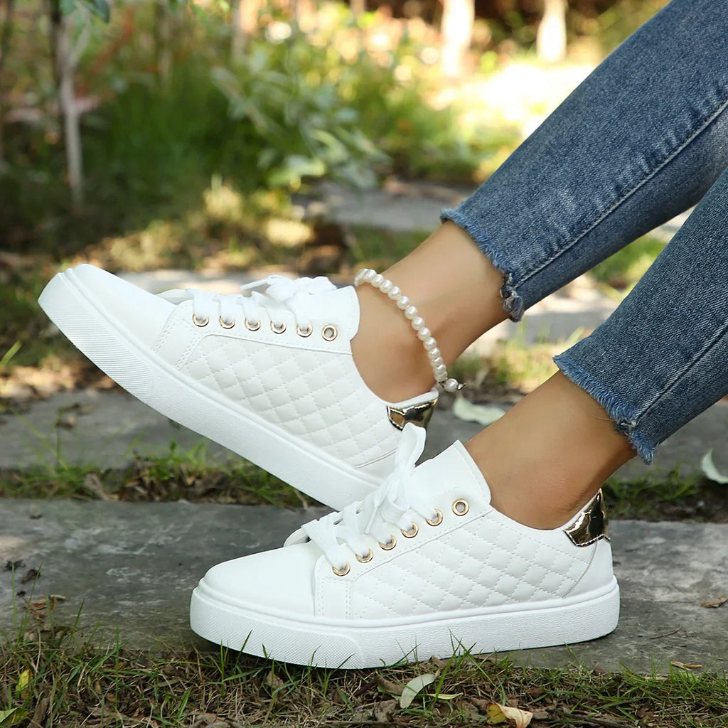 White quilted lace-up platform sneakers with gold eyelets and white rubber sole
