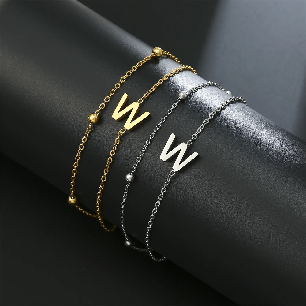 Initial letter bracelet set with N and W charms; gold and silver-tone chains
