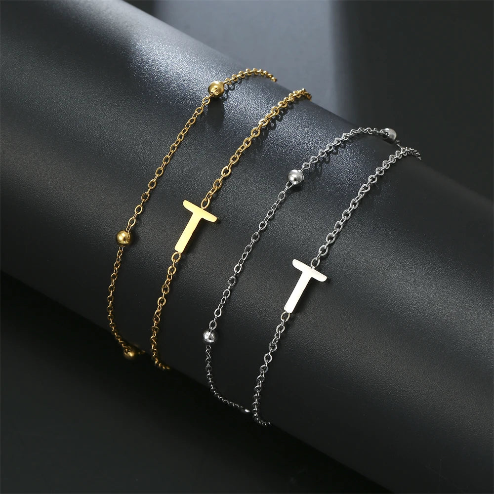 Initial letter bracelet set with T and T charms; gold and silver-tone chains