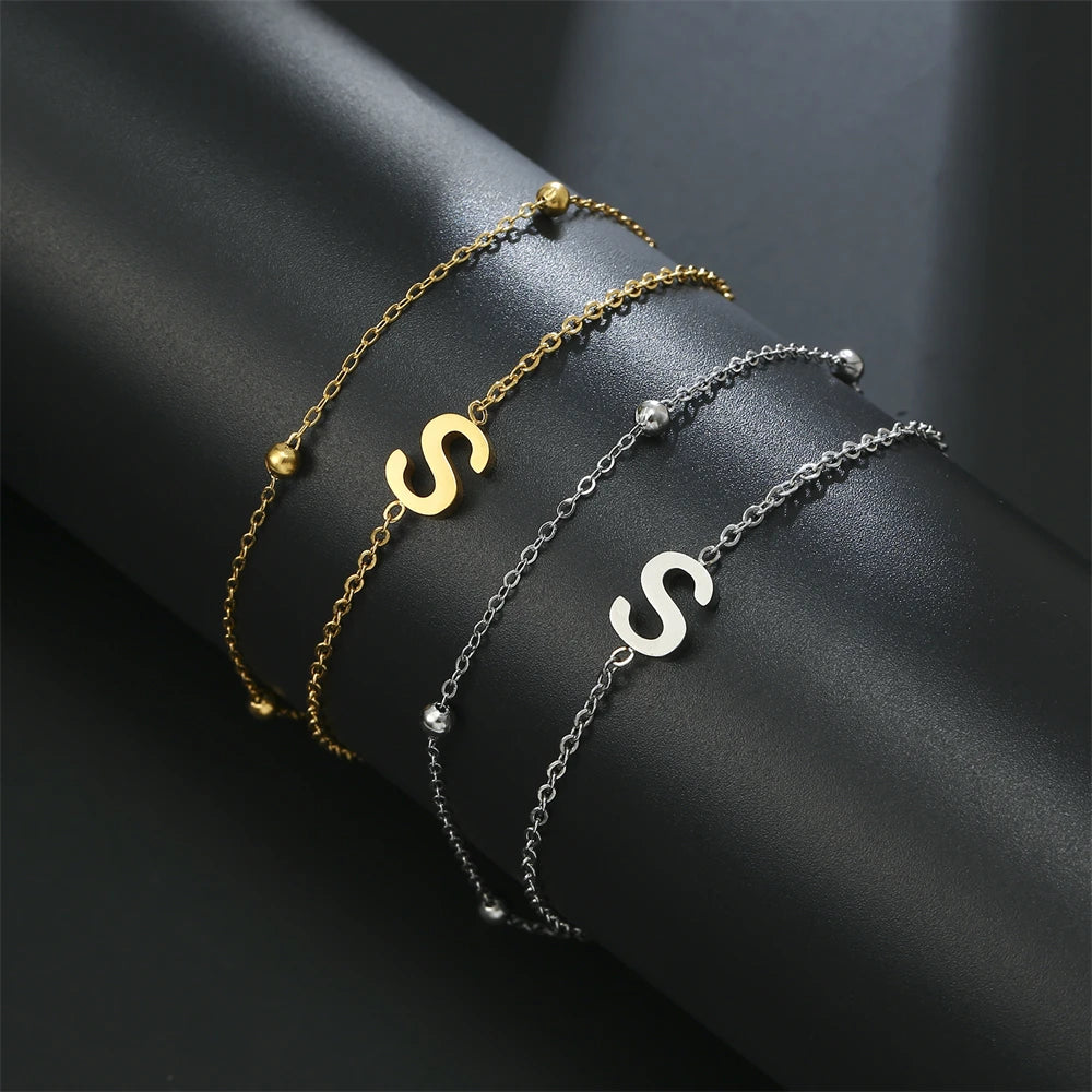Initial letter bracelet set with S and S charms; gold and silver-tone chains