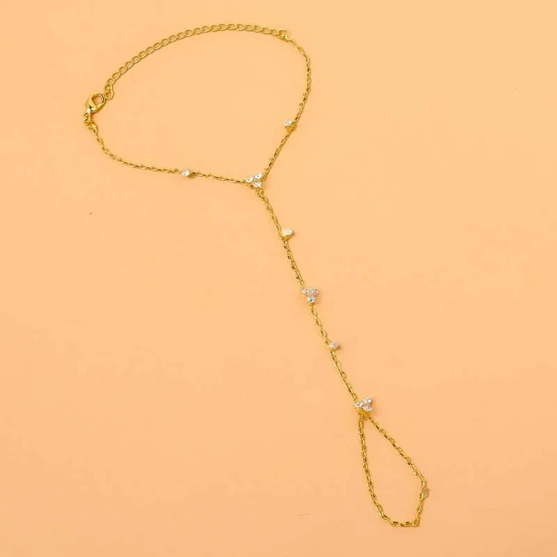 Gold rhinestone flower charm bracelet with slender chain and teardrop dangling crystal charms