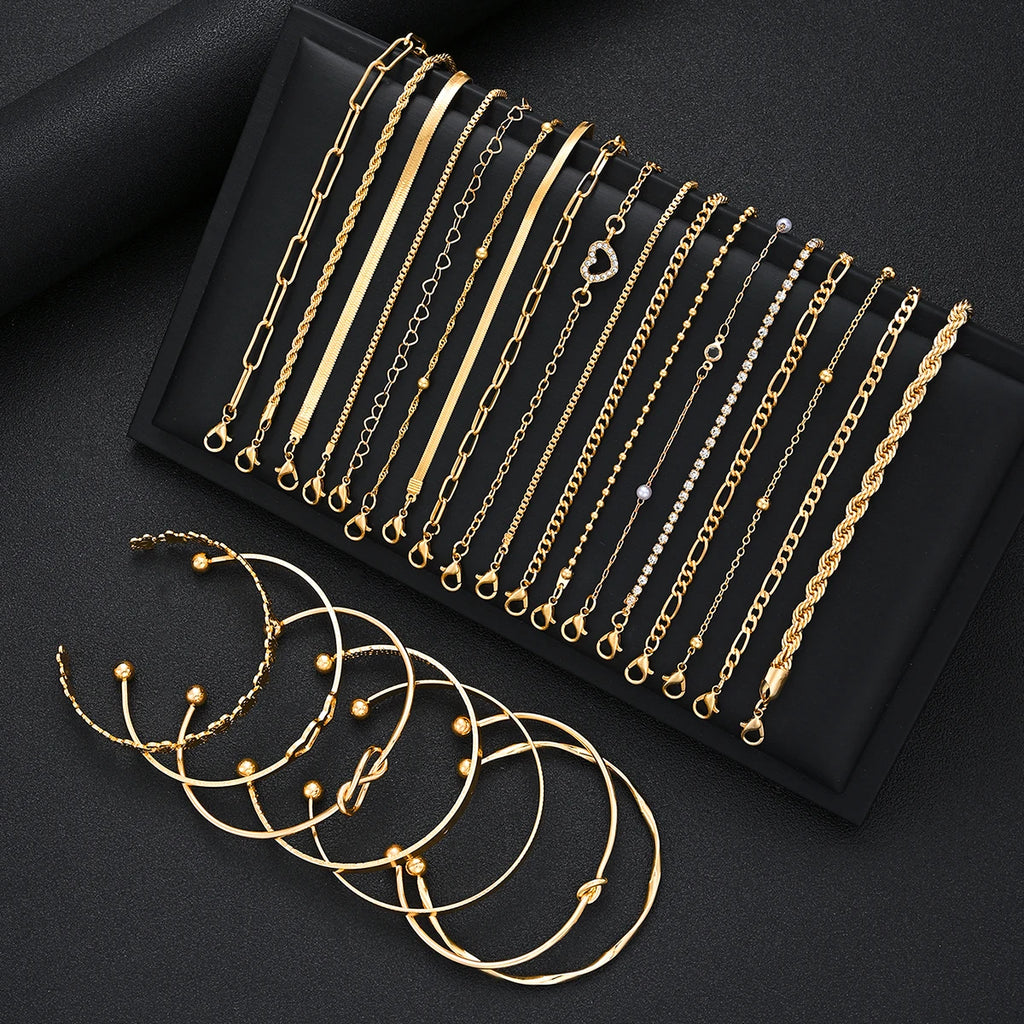 Gold-tone charm bracelet set with heart loops and pearl-like bead accents