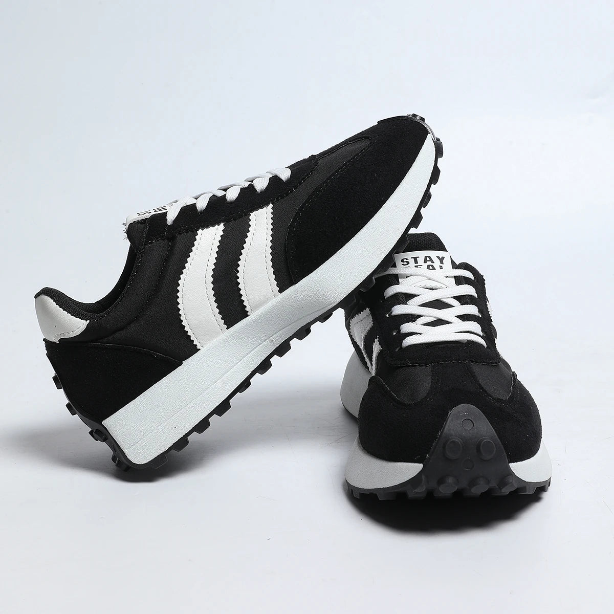 Women's lace-up sneakers, black with white side stripes and thick white-rim sole