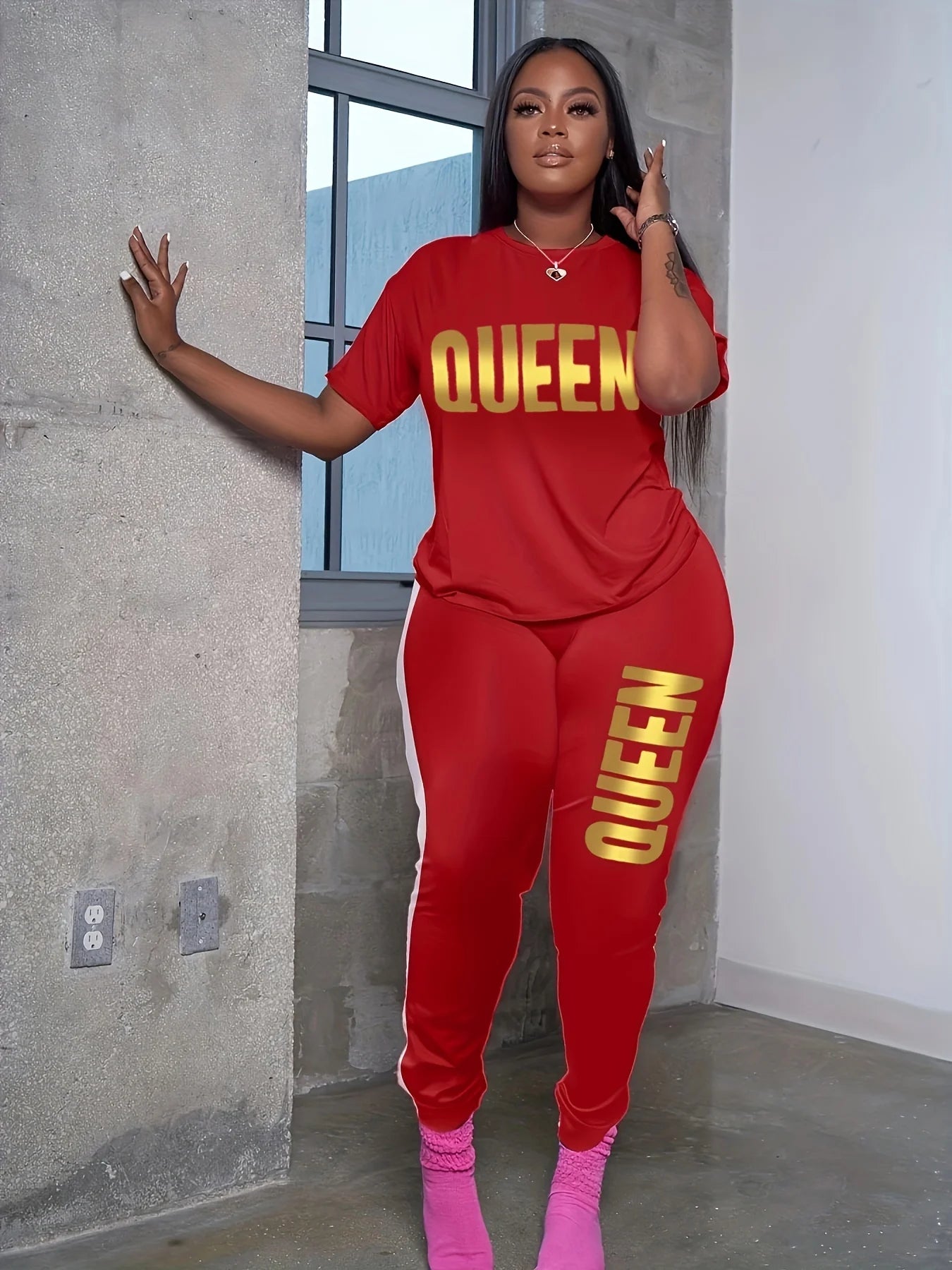 Red plus-size T-shirt and jogger set with yellow QUEEN print on chest and leg.