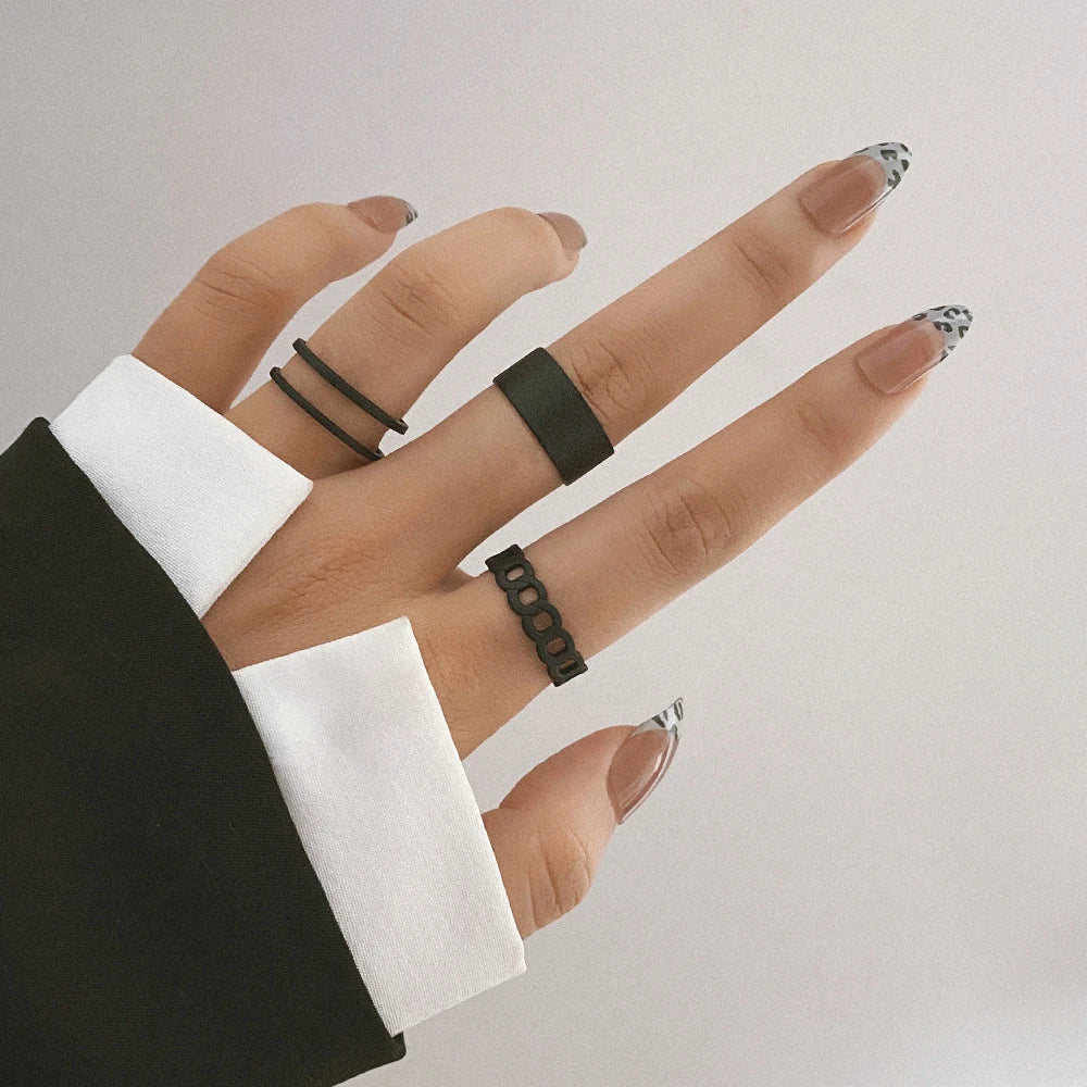 Black knuckle chain rings on fingers, small geometric link design