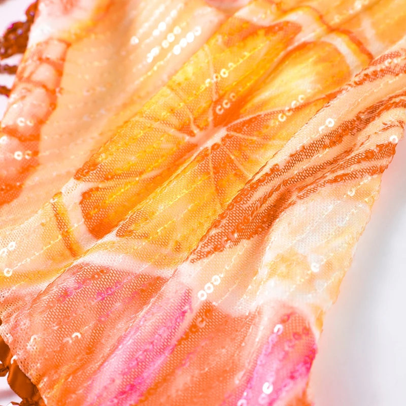 Tropical print mesh fabric with sequin accents and pink orange yellow tones
