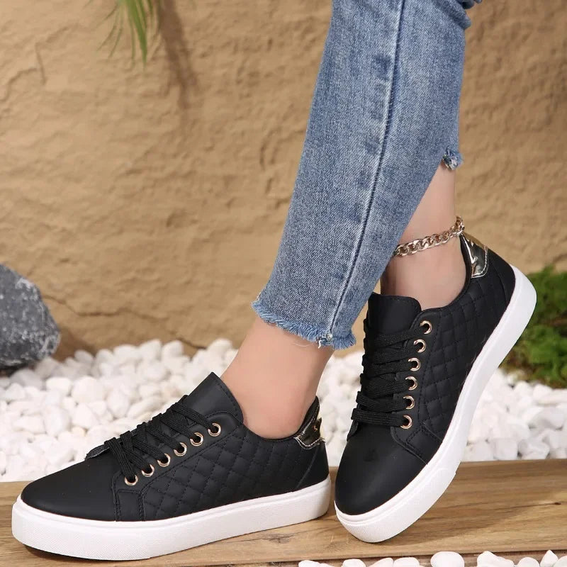 Black quilted lace-up platform sneakers with gold eyelets and white rubber sole