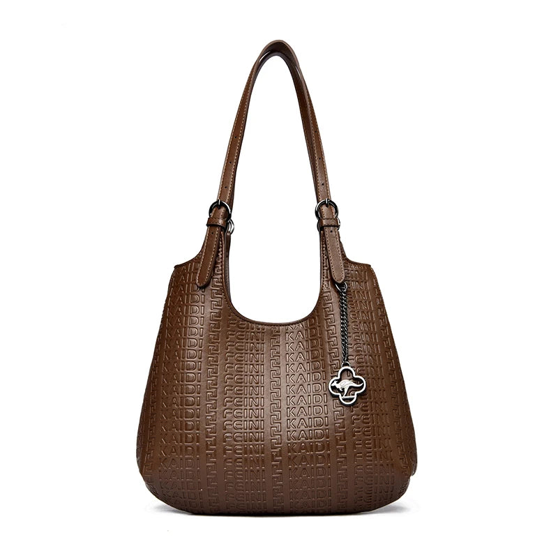 Brown embossed leather shoulder tote with top handles and flower logo charm