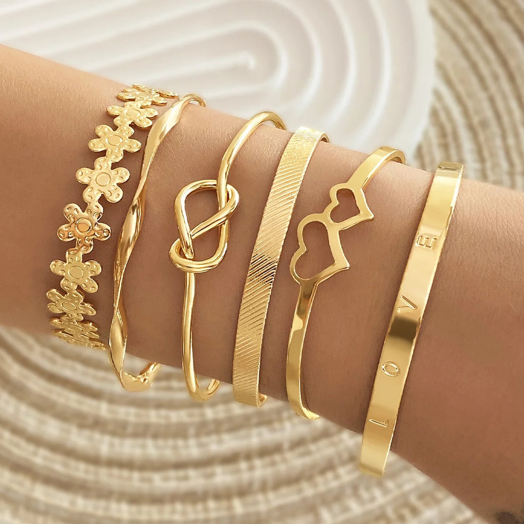 Gold-tone heart charm cuff and beaded bracelets with pearl-like detail accents