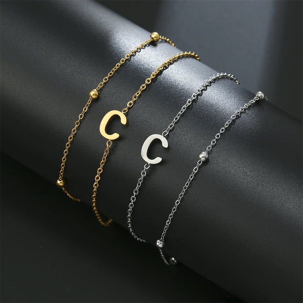 Initial letter bracelet set with C and C charms; gold and silver-tone chains