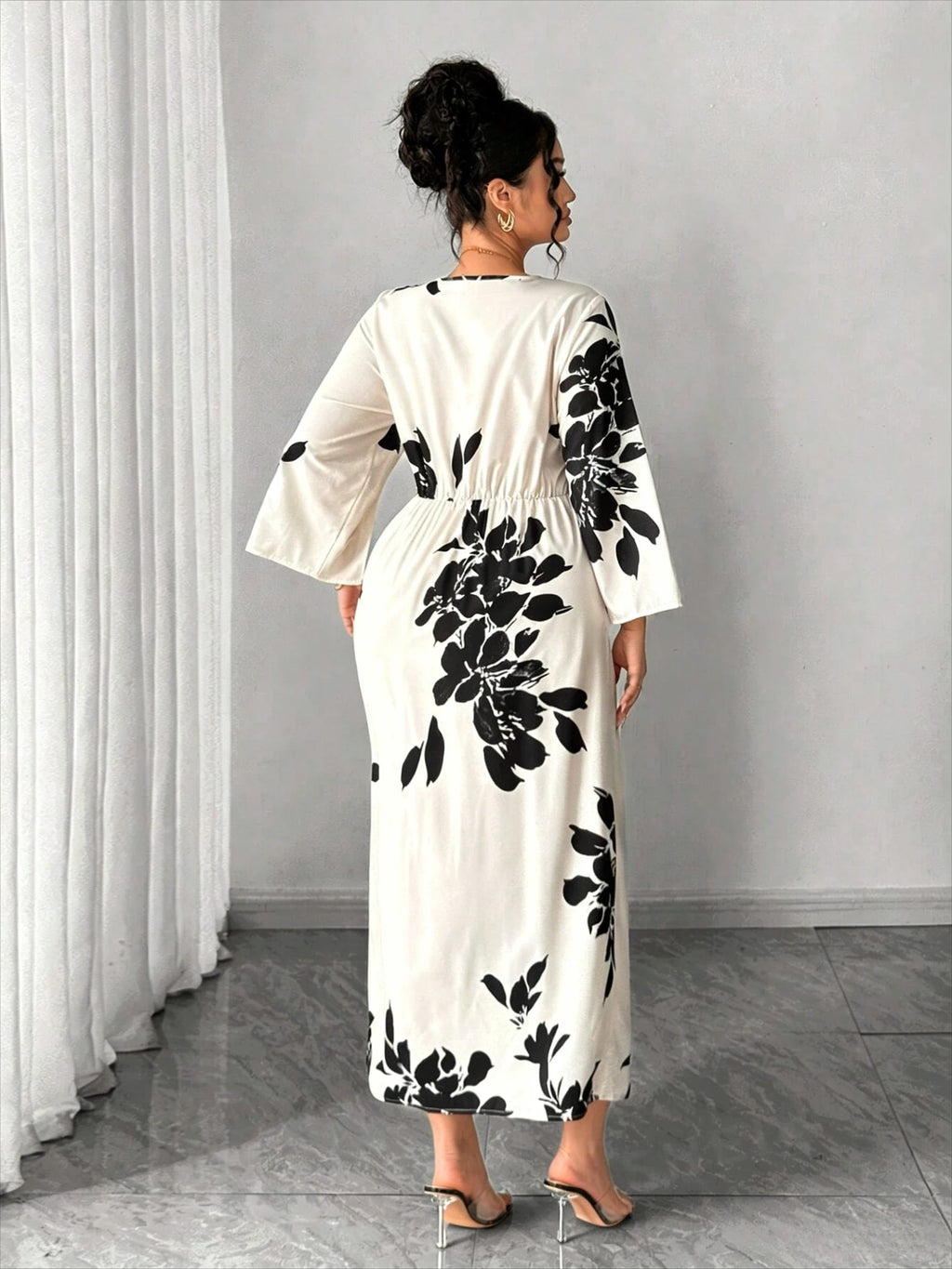 Back view white midi dress with black floral print, 3/4 sleeves, center slit