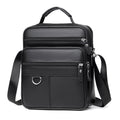 Black leather crossbody bag with top handle, front flap with metal ring, two zip rows